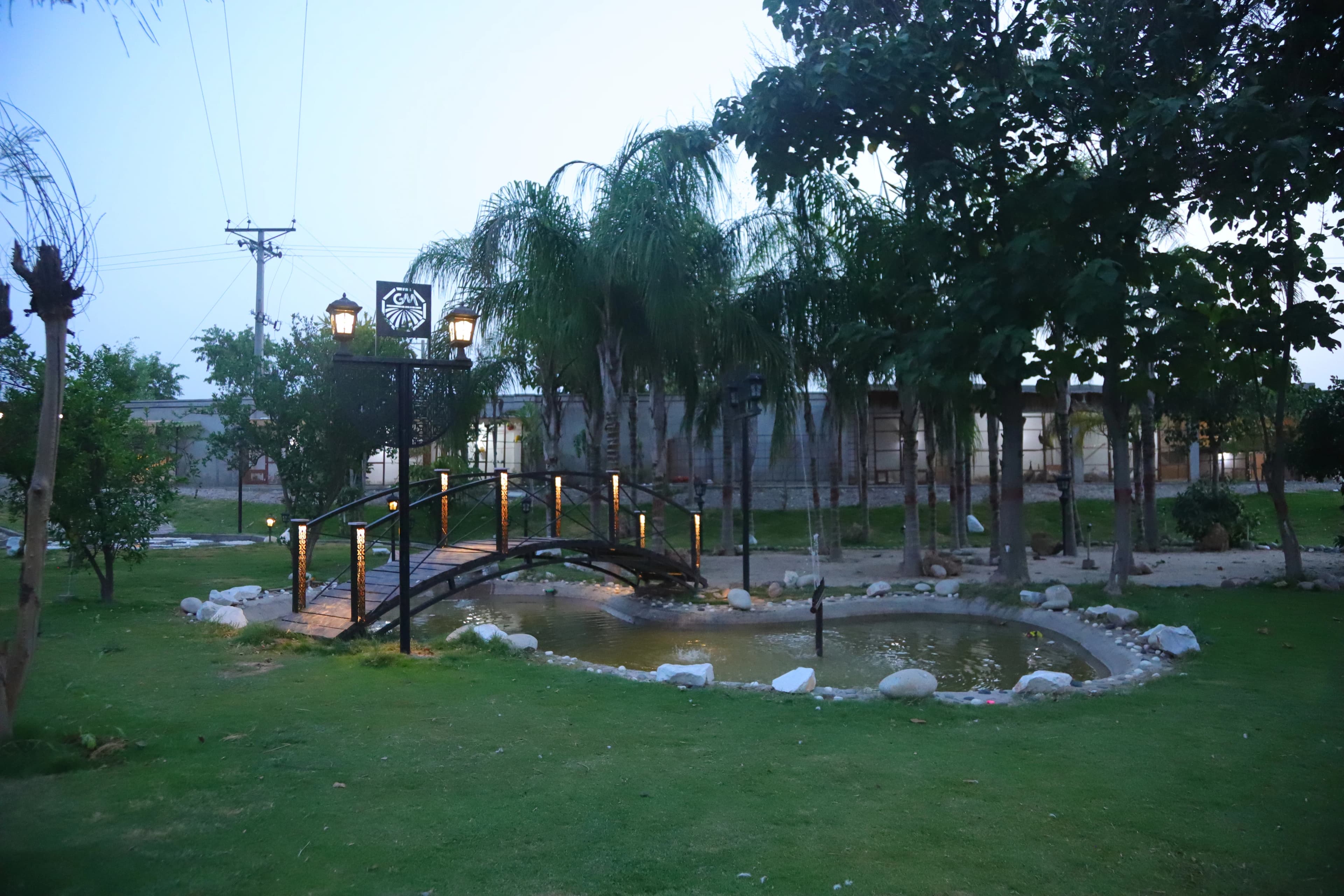 Bridge and water feature at dusk with warm venue lights