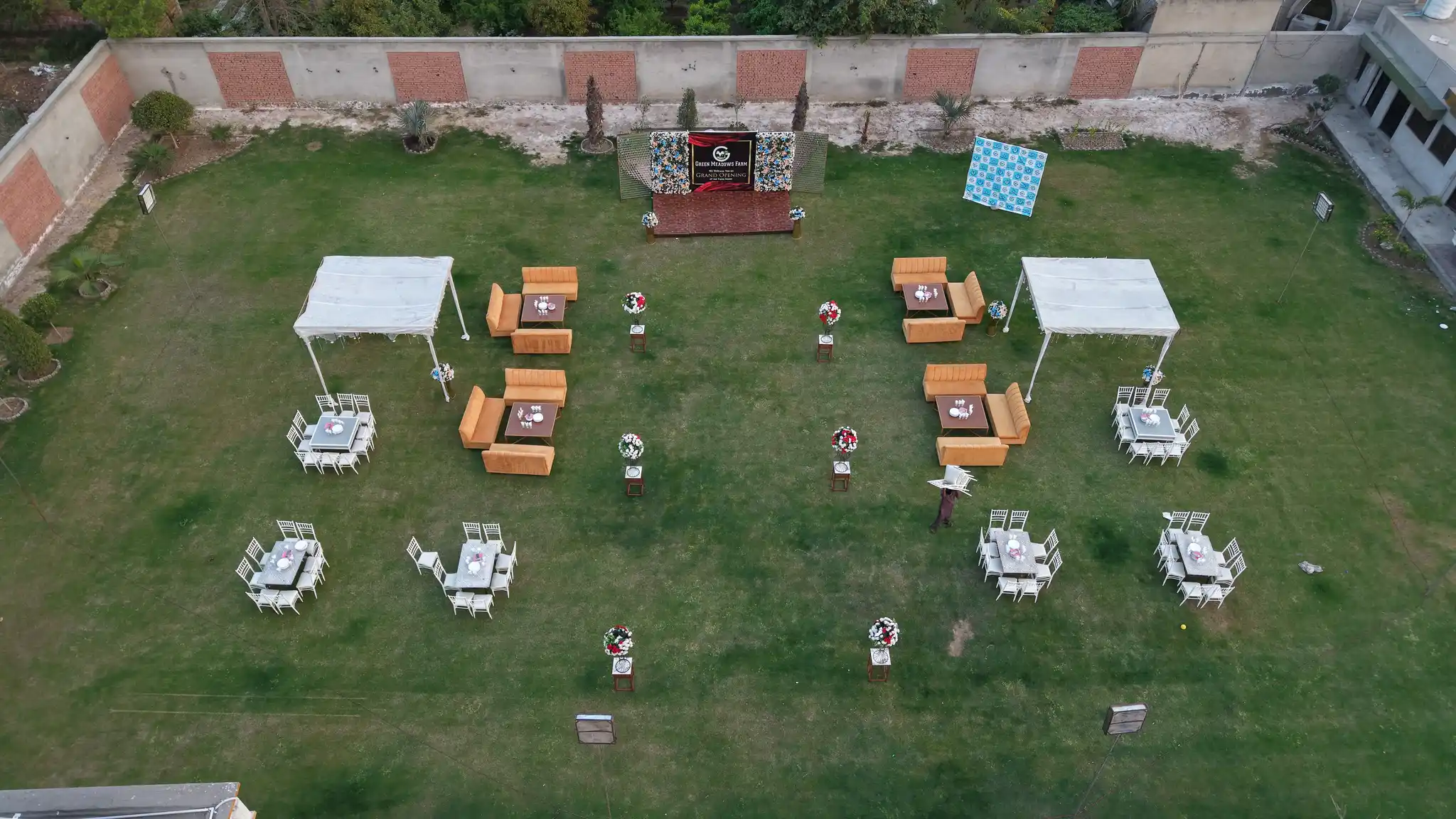 Decorated event lawn setup beside the farmhouse pool