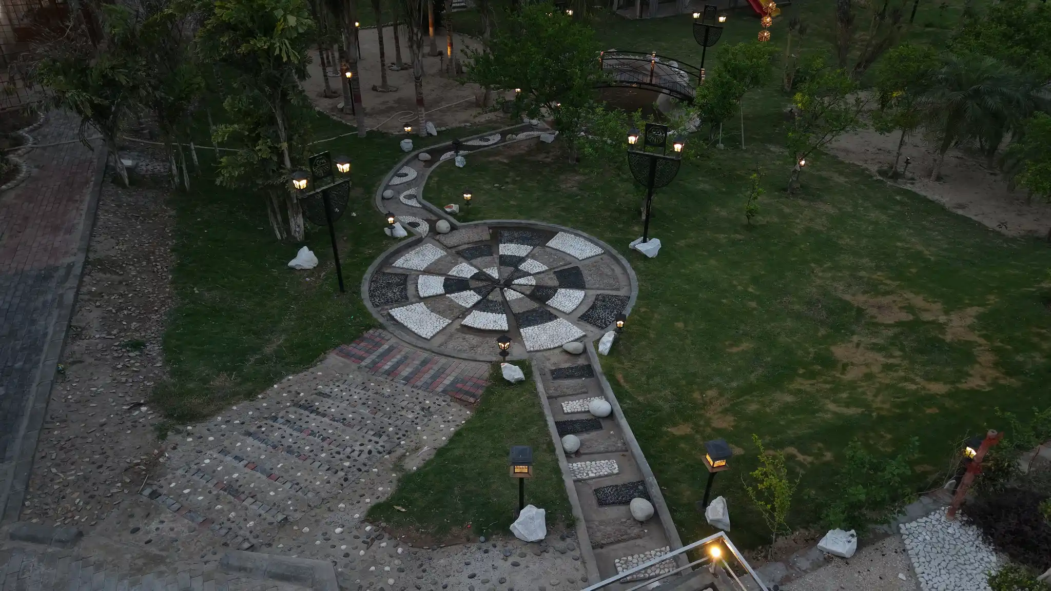 Evening aerial of Green Meadows Farm with the garden lights turned on