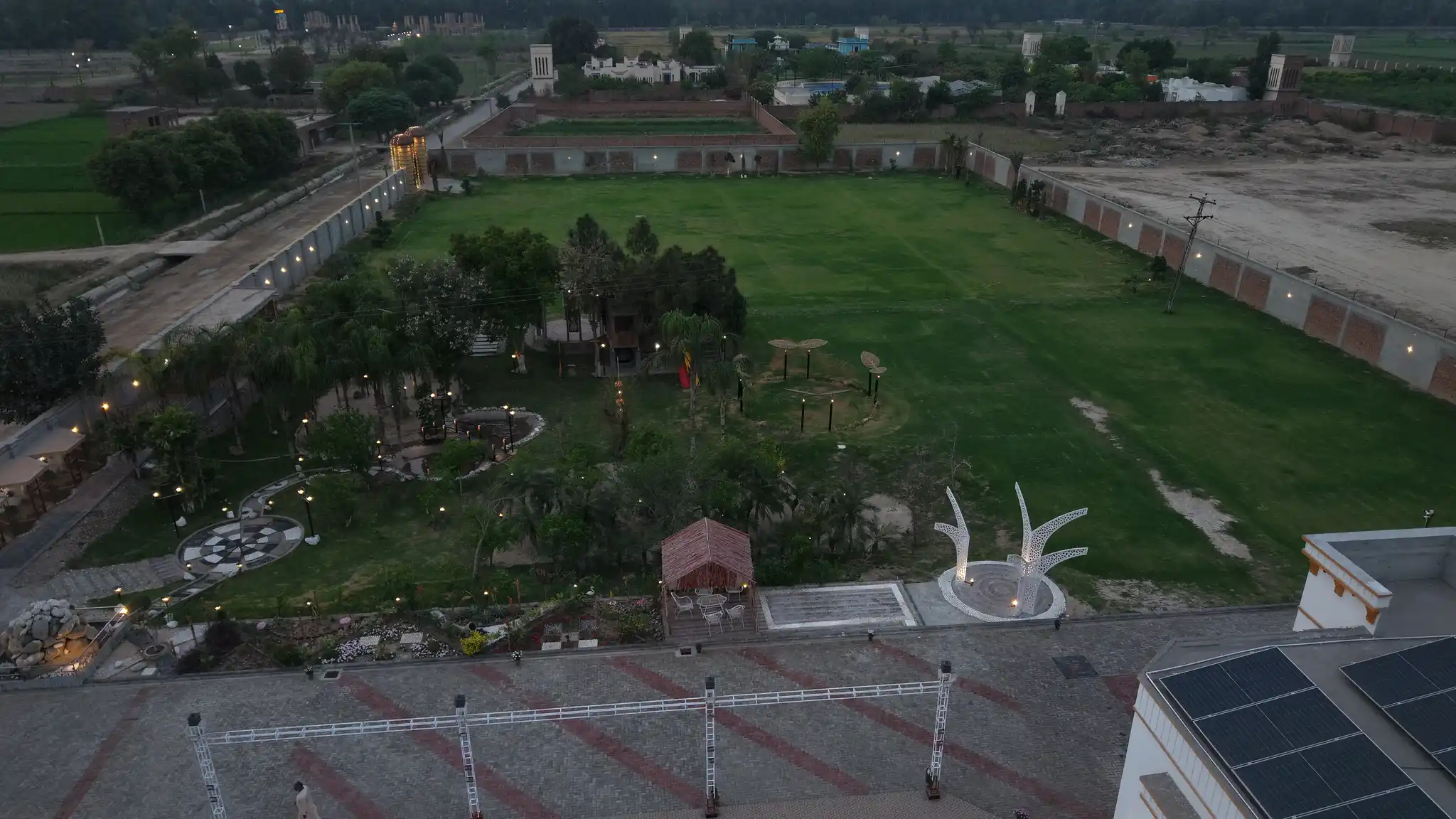 Drone shot of the full farmhouse grounds from above at sunset